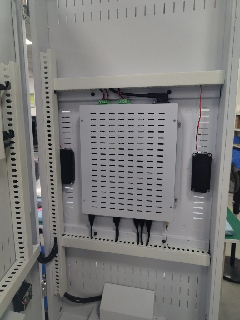 Technician checking internal kiosk cables after power isolation
