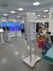 Outdoor ordering kiosk operating near a transport location at night