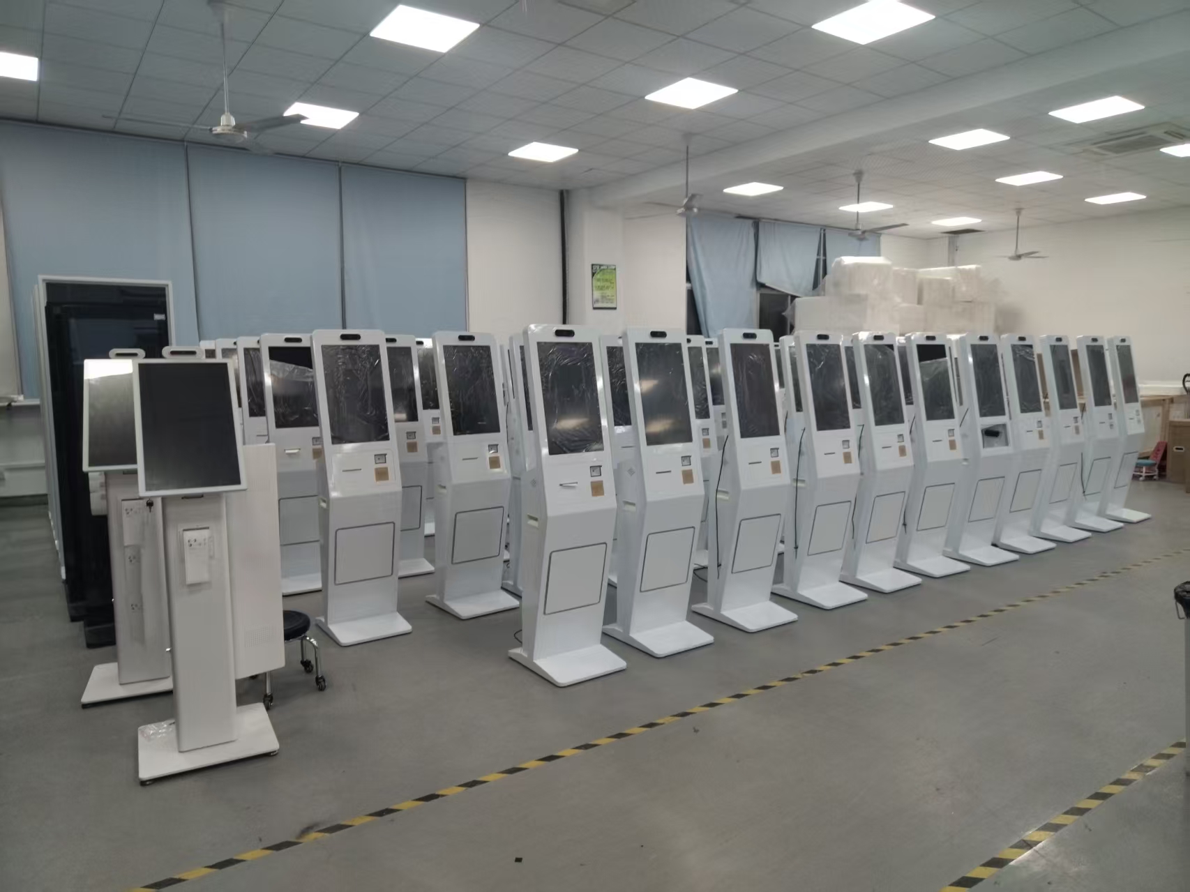 Finished self-service kiosks standing in rows before shipment